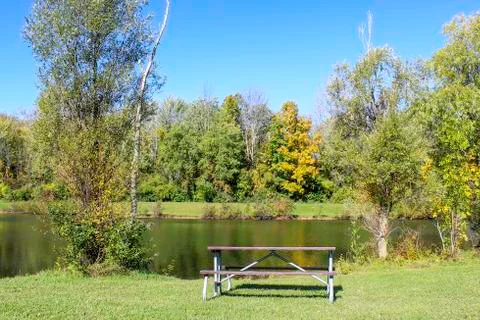 Picnic table on the pond Stock Photos