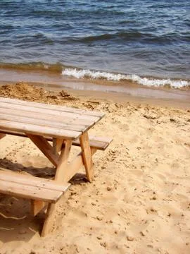 Picnic table in sand Stock Photos