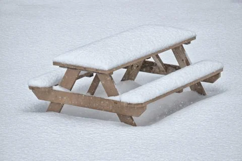 Picnic table in snowfall Stock Photos