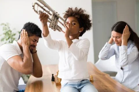 Picture of child making noise by playing trumpet Stock Photos