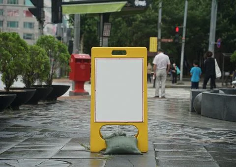 A picture of an empty warning board neck-up on a rainy day Stock Photos