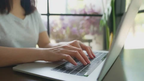 The picture of the finger is typing the keyboard on the notebook. There is a  Stock Footage 154696559