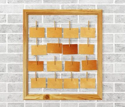 Picture frame and antique note papers on white brick wall Stock Illustration