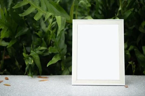 The picture frame is placed on the cement table. Stock Photos