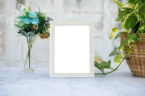The picture frame is placed on the cement table. Stock Photos