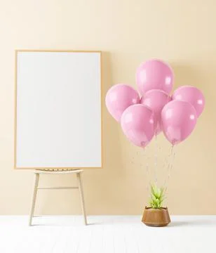 A picture frame is placed on a shelf with floating balloons tied to a plant.. Stock-Fotos