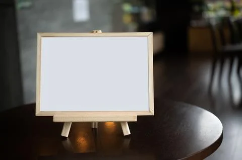 Picture frame placed on a table in a restaurant. Stock Photos