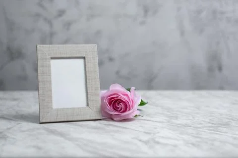 Picture frame portrait on marble table. Mockup. Stock Photos