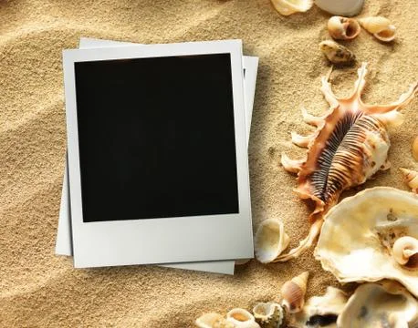 Picture frame on shells and sand background Stock Photos
