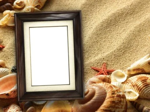 Picture frame on shells and sand background Stock Photos