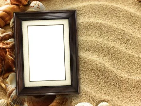 Picture frame on shells and sand background Stock Photos