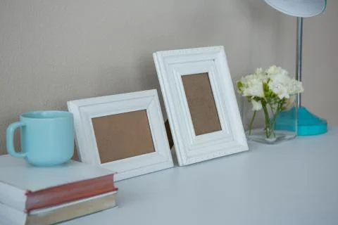 Picture frames, coffee cup with and flower vase Stock Photos