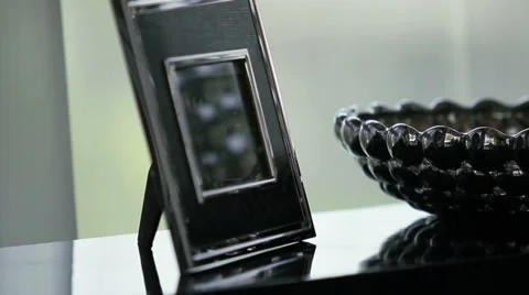 Picture frames on side table Stock Footage 62860514