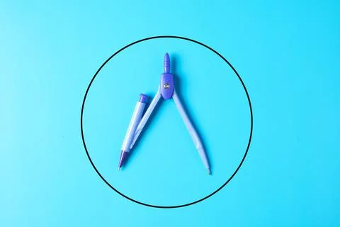 A picture of geometry compass with circle on blue background 스톡 사진