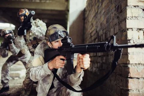 A picture of guy looking for an aim. He is loooking through loop gun. He is Stock Photos