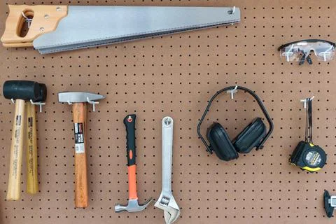 Picture hanging on the wall with various types of tools Stock Photos
