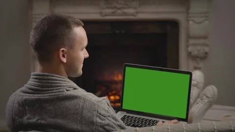 Picture of motionless young guy watching a movie on a laptop in the living room Stock Footage 98322988