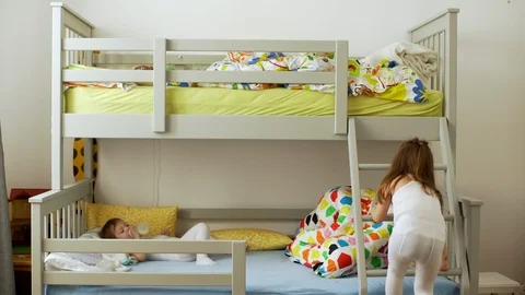Picture of small two children resting in bedroom and lying in bunk bed with Stock Footage 85573524