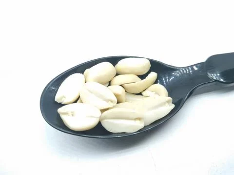 A picture of split Peanuts on a black spoon Stock Photos