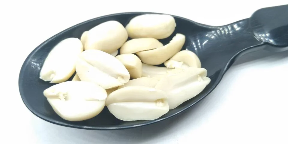 A picture of split Peanuts on black spoon Stock Photos