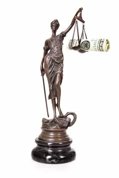 A picture of a Themis statue with dollar notes on the scale as a symbol of .. Stock-Fotos