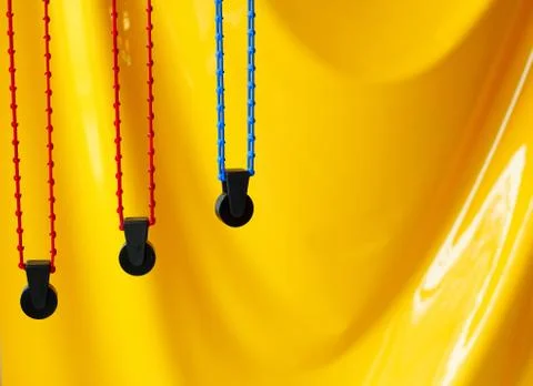 Picture of  three rollers for background in photo studio over yellow wall Foto stock
