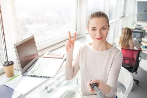A picture that was made from a different angle where beautiful office worker is Fotos de archivo