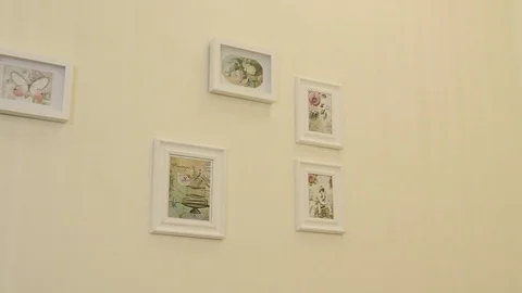 Pictures hang on the wall Stock Footage 75937782