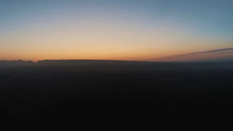 Picturesque aerial view of fields surrounded in fog with a clear sky, during  Stock Footage 114453224