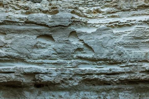 Picturesque background of collapsing surface of limestone rock. Abstract beau Stock Photos