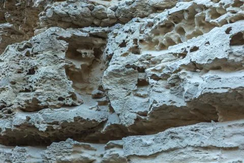 Picturesque background of collapsing surface of limestone rock. Abstract beau Stock Photos