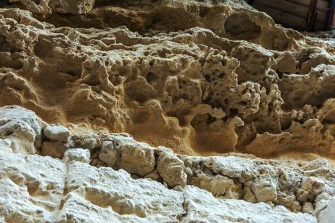 Picturesque background of collapsing surface of limestone rock. Abstract beau Stock Photos