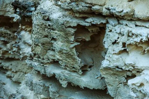 Picturesque background of collapsing surface of limestone rock. Abstract beau Stock Photos