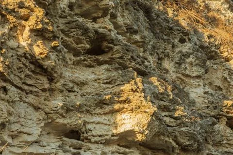 Picturesque background of collapsing surface of limestone rock. Abstract beau Stock Photos