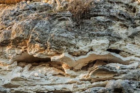 Picturesque background of collapsing surface of limestone rock. Abstract beau Stock Photos