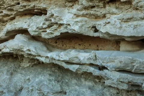 Picturesque background of collapsing surface of limestone rock. Abstract beau Stock Photos