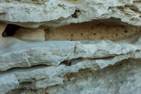 Picturesque background of collapsing surface of limestone rock. Abstract beau Stock Photos