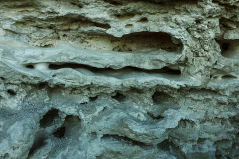 Picturesque background of collapsing surface of limestone rock. Abstract beau Stock Photos