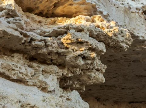 Picturesque background of collapsing surface of limestone rock. Abstract beau Stock Photos