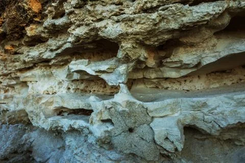 Picturesque background of collapsing surface of limestone rock. Abstract beau Stock Photos