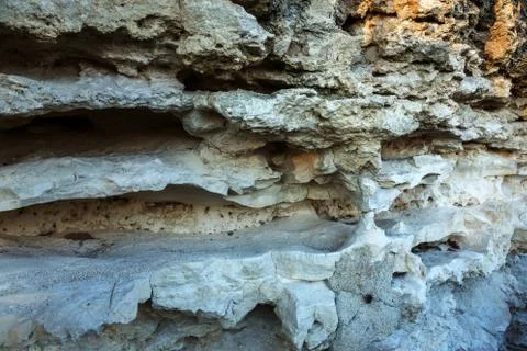 Picturesque background of collapsing surface of limestone rock. Abstract beau Stock Photos