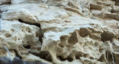 Picturesque background of collapsing surface of limestone rock. Abstract beau Stock Photos