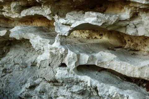 Picturesque background of collapsing surface of limestone rock. Abstract beau Stock Photos