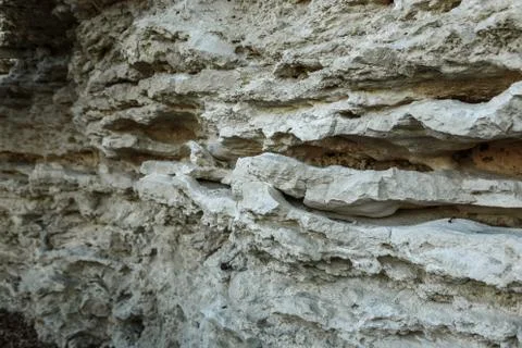 Picturesque background of collapsing surface of limestone rock. Abstract beau Stock Photos