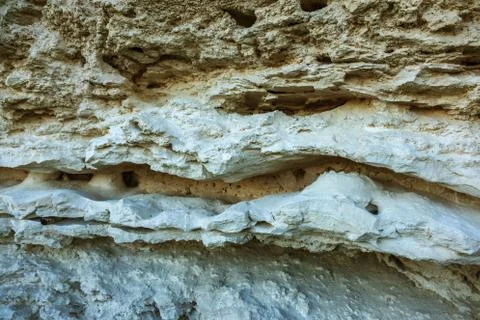 Picturesque background of collapsing surface of limestone rock. Abstract beau Stock Photos