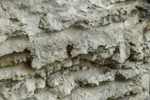 Picturesque background of collapsing surface of limestone rock. Abstract beau Stock Photos