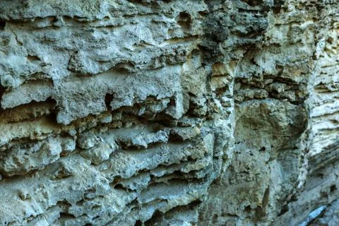 Picturesque background of collapsing surface of limestone rock. Abstract beau Stock Photos
