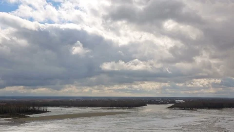 Picturesque clouds floating above the river during ice drift. Time Lapse. Stock Footage 106183058