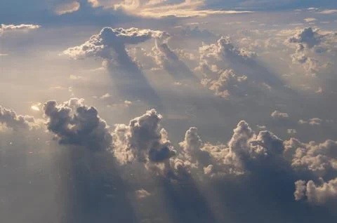 Picturesque cloudscape with sunlight and shadows, view from above background Stock Photos