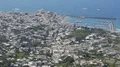 Picturesque coastal town lying at harbor with docked boats calm blue sea at back HD Footage
